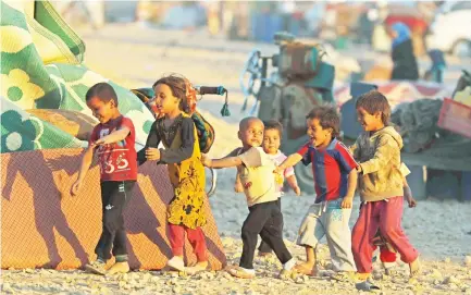  ??  ?? Children play inside a refugee camp on Wednesday in Ain Issa, Syria. (Reuters)