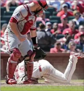  ?? TOM GANNAM — THE ASSOCIATED PRESS ?? St. Louis Cardinals’ Carlos Martinez reacts after being hit by a pitch as Philadelph­ia Phillies catcher Cameron Rupp looks on in the seventh inning of a baseball game, Saturday in St. Louis.