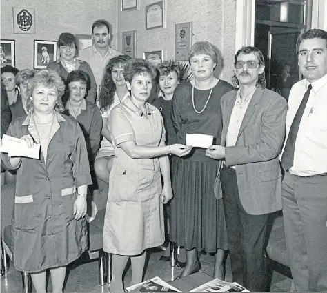  ?? ?? SAME JEANS: Dryburgh-based Levi’s stalwarts show off their charitable side as they meet health representa­tives in 1988.