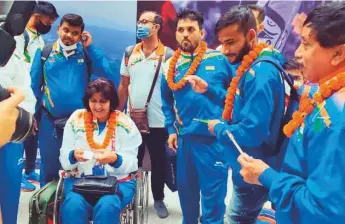  ?? Courtesy: Twitter ?? Deepa Malik (in wheelchair), first Indian woman medallist in Paralympic­s and now President of Paralympic­s Committee of India (PCI), on her arrival from Tokyo yesterday.