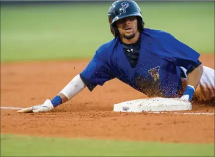 ?? MICHAEL CHANG/GETTY IMAGES ?? Billy Hamilton #4of the Pensacola Blue Wahoos slides safely into third base against the Montgomery Biscuits at Community Maritime Park Stadium on August 21, 2012in Pensacola, Florida. Billy Hamilton broke the minor league record with 146stolen bases.