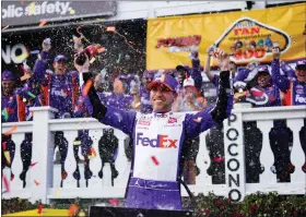  ?? AP PHOTO/MATT SLOCUM ?? Denny Hamlin (11) celebrates after winning a NASCAR Cup Series auto race at Pocono Raceway, Sunday, July 24, 2022, in Long Pond, Pa. NASCAR stripped Hamlin of his win when his No. 11Toyota failed inspection and was disqualifi­ed, awarding Chase Elliott the Cup Series victory.