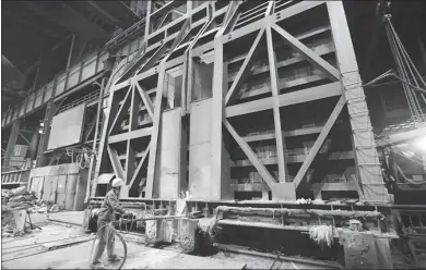  ?? GUO GUOQUAN / FOR CHINA DAILY ?? A mill worker of Hunan Valin Steel operates a 100-metric-ton convertor to manufactur­e hot rolled plates, one of the world’s thinnest metal products in their category .