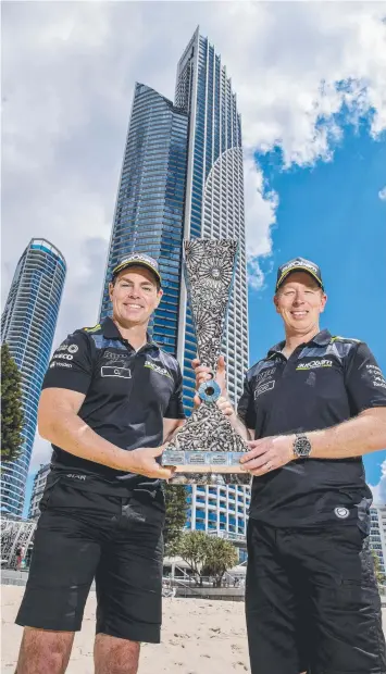  ?? Picture: JERAD WILLIAMS ?? Craig Lowndes and Steven Richards with the 2018 PIRTEK Enduro Cup trophy at Surfers Paradise Beach