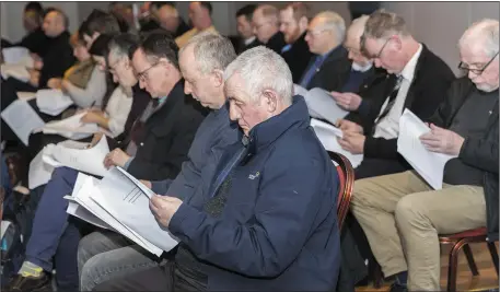  ??  ?? Attendees look over the club accounts.