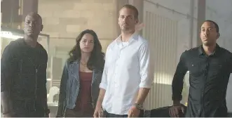  ?? SCOTT GARFIELD/ UNIVERSAL PICTURES ?? Tyrese Gibson, left, Michelle Rodriguez, Paul Walker and Chris ( Ludacris) Bridges in Furious 7. The Furious series boasts actors who represent a wide spectrum of ethnic background­s.