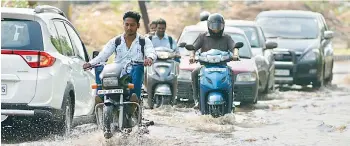  ?? —DC ?? Vehicles ply through the water-clogged road at Necklace road in the city on Wednesday.