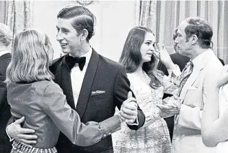  ?? CHUCK MITCHELL THE CANADIAN PRESS FILE PHOTO ?? A young Prince Charles dances during a state dinner party in July 1970, while Miss Caanda Julie Maloney chats with Prime Minister Pierre Trudeau..