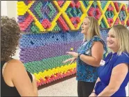  ?? (NWA Democrat Gazette/Dave Perozek) ?? Vaughn Elementary School teachers Nanci Krapf (from right) and Amanda Coughlin chat with a visitor in a hall next to the “noodle wall” during the open house and ribbon cutting at the school on July 18 in the Vaughn community. Vaughn Elementary, the Bentonvill­e School District’s 13th elementary school, is set to open to students in August. Visit nwaonline.com/220725Dail­y/ for today’s photo gallery.