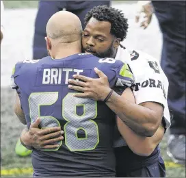  ?? AP ?? Seattle offensive lineman Justin Britt shows his support for Michael Bennett after the defensive end sat on the bench during the national anthem before a recent game.