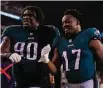  ?? Mitchell Leff/Getty Images ?? The Eagles’ Jordan Davis (90) and Nakobe Dean celebrate after a win over the Vikings.