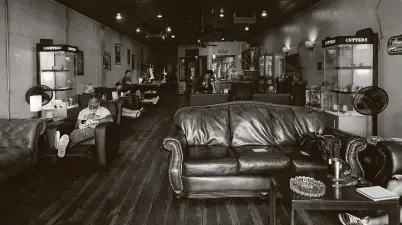  ?? Yi-Chin Lee / Staff photograph­er ?? Heights Cigar Lounge reached its maximum capacity of nine customers inside at a time for the first time Thursday since reopening May 1.