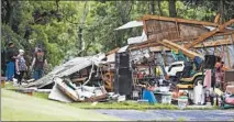  ?? ROBERT FRANKLIN/SOUTH BEND TRIBUNE ?? Residents of South Bend, Indiana, look at damage on June 24 after a tornado descended on the south side.