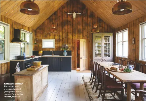  ??  ?? Kitchen-diner The timber walls were sandblaste­d, giving them a rich texture. For a similar
kitchen, try Pluck