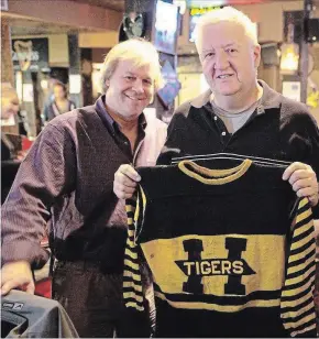  ?? SUBMITTED PHOTO ?? Hockey Hall of Fame curator Phil Pritchard, left, and Russ Boychuk show what might be the only known 1925 Hamilton Tigers sweater to exist.