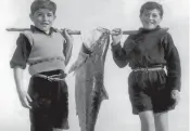  ??  ?? Tony Muollo, left, and brother Carl, with Marist Newtown school belts on show, wag school for a day’s fishing. Below, with fiancee Anna Maria at the time of their engagement in Sorrento, Italy.