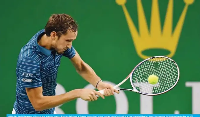  ?? AFP ?? SHANGHAI: Daniil Medvedev of Russia hits a return against Stefanos Tsitsipas of Greece during their men’s singles semi-final match at the Shanghai Masters tennis tournament in Shanghai yesterday. —