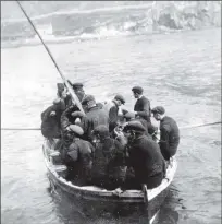  ??  ?? Clockwise from left: St Kilda’s resident don their best clothes; a ferry boat is packed; Christina Ann McQueen (centre), daughter of Finlay McQueen, outside the factor’s house, St Kilda, c 1913; a copy of the census document; and St Kildans with Soay...