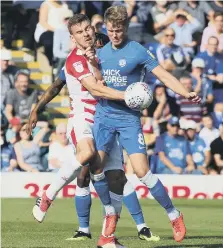  ??  ?? Posh midfielder Mark O’Hara battles with Doncaster’s Andy Butler.