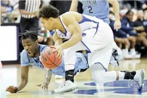  ?? AP Photo/Adam Hunger ?? ■ Villanova guard Bryan Antoine grabs a loose ball in front of Villanova forward Brandon Slater Saturday during the first half of an NCAA college basketball game in Newark, N.J.