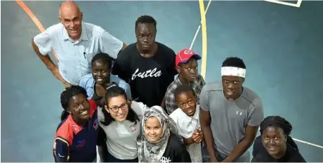  ?? LACEY PHOTO: BEV ?? YOUTH GROUP: Pastor Ross Savill of HumeRidge Church of Christ, with (back, from left) Monica Mach, David Deng and Isaac Barac and (front, from left) Mary Barac, volunteer Emma Terry, Hadeel Hussain, Peter Barac, Peter Deng and Phoebe Barac.