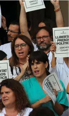  ??  ?? Medical workers protest during a gathering in Barcelona after the leaders of two Catalan separatist organisati­ons were jailed by Spain’s High Court. Photo: Reuters/Albert Gea