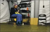  ??  ?? Chris Rutledge, a nurse for Samaritan’s Purse, eats during the only short break of her 12-hour shift inside a COVID-19 field hospital in Lenoir, N.C.