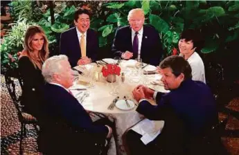  ?? Reuters ?? Japanese Prime Minister Shinzo Abe and his wife Akie Abe attend dinner with US President Donald Trump and his wife Melania at Mar-a-Lago Club in Palm Beach, Florida, on Friday.