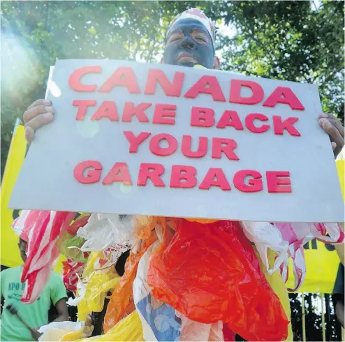  ?? JAY DIRECTO / AFP / GETTY IMAGES ?? An activist takes part in a rally in Manila last month to demand that shipping containers filled with garbage
be sent back to Canada. The incident has angered politician­s, straining Canadian-Filipino relations.