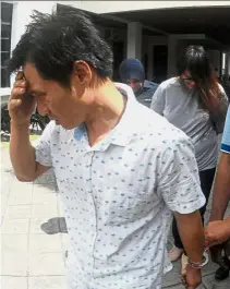  ??  ?? Repentant: Keng Liang (left) and Su- Quinn arriving at the Magistrate’s Court in George Town, Penang.