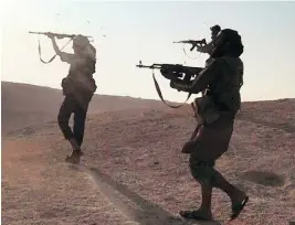  ?? MILITANT PHOTO VIA AP ?? This undated image posted online by ISIL supporters purports to show Islamic State fighters firing their weapons during clashes with Syrian troops in August.
