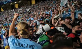  ?? Photograph: Ozan Köse/AFP/Getty Images ?? Erling Haaland celebrates with City fans, who experience­d long delays to get to and from the Ataturk Olympic Stadium on the outskirts of Istanbul.