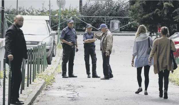  ?? PICTURE: CZAREK SOKOLOWSKI/AP ?? 0 Police in Warsaw outside the Niebo, or Heaven, club where US rock band Allah-las was due to take place last night under strict security