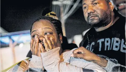  ?? MARCUS YAM THE ASSOCIATED PRESS ?? Latrice Radford is consoled outside the Gable House Bowl where her brother, 20-year-old Michael, was shot and killed.