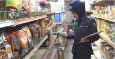  ??  ?? A KPDNKK officer inspects prices of goods at a premises in Sungai Asap.