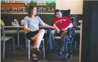  ?? MELISSA GOLDEN/THE NEW YORK TIMES ?? Kimberlee Harkins sits with her brother Eric Harkins, who has cerebral palsy, recently at a local ice cream parlor in Birmingham, Ala. Optional benefits received by millions, many of them disabled, would be at risk under Republican proposals to repeal...