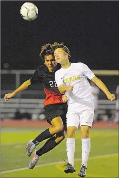  ?? DANA JENSEN/THE DAY ?? Montville’s Jack Minas (22) and Stonington’s Tyler Fidrych battle in the air during Monday’s game in Stonington, where the Bears completed their first unbeaten regular season since 1994 with a 4-0 win over the Indians.