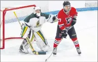  ?? DAVID JALA/CAPE BRETON POST ?? Memorial goalie Gavin Rudderham keeps an eye on the puck while making sure he knows exactly where Glace Bay forward Christian Jackson is during first period action of Sunday’s Cape Breton High School Hockey League game at the Canada Games Complex. The...