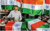  ?? — PTI ?? A tailor stitches flags for the upcoming Independen­ce Day at a shop in Kolkata on Monday.