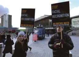  ?? CP/AP PHOTO KELVIN CHAN ?? People demonstrat­e in front of a mobile police facial recognitio­n facility outside a shopping centre in London on Feb. 2020. Dozens of groups and individual­s working to protect privacy, human rights and civil liberties want the Trudeau government to ban the use of facial-recognitio­n surveillan­ce by federal law-enforcemen­t and intelligen­ce agencies.