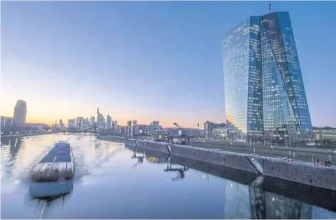  ?? DPA/AFP ?? A barge makes its way on the River Main past the headquarte­rs of the European Central Bank in Frankfurt.