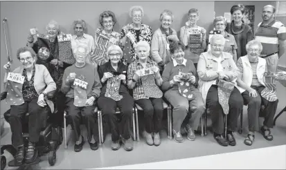  ?? Herald photo by Amanda Michalezki ?? Residents of Martha’s House seniors home display some of the more than 70 Christmas stockings made for the Operation Christmas Stocking project at Chinook Regional Hospital.