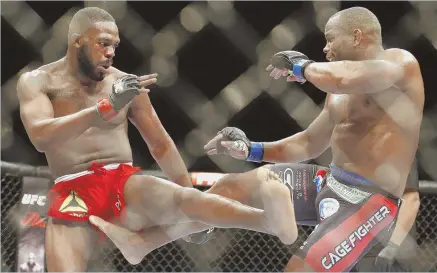  ?? AP FILE PHOTO ?? RE-BOOT: Daniel Cormier, right, kicks Jon Jones during his loss in their light heavyweigh­t title match at UFC 182 in January 2015. Cormier gets his long awaited rematch Saturday.