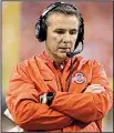  ?? AP file photo ?? After he was suspended the first three games of the season by the school for mishandlin­g domestic violence accusation­s involving an assistant, Ohio State Coach Urban Meyer, reading from a statement, said, “I followed my heart and not my head.”