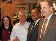  ?? BRIAN MCCULLOUGH — DIGITAL FIRST MEDIA ?? Shown at Friday’s opening of wine sales at the Downingtow­n Wegmans are, from left: wine manager Michelle Nick, store manager Kurt Husebo, state Rep. Harry Lewis Jr. and state Rep. Duane Milne.