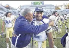  ?? ROBERT WILLETT / RALEIGH NEWS & OBSERVER ?? Georgia Tech chaplain Derrick Moore embraces quarterbac­k Vad Lee as they celebrate a 68-50 victory over North Carolina.