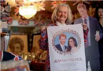  ?? AFP ?? Tyler holding memorabili­a celebratin­g the forthcomin­g wedding of Prince Harry to his fiancee Meghan, in her home in London. —