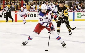  ?? Emilee Chinn / Getty Images ?? The Rangers’ Mika Zibanejad controls the puck against the Penguins during Game 4 of their first-round Stanley Cup playoff series on Monday.