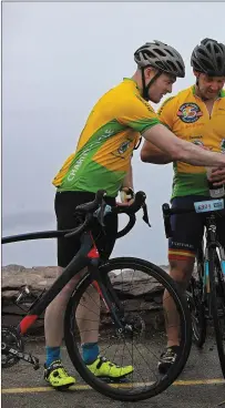  ??  ?? No water shortage at Coomakiste as John Garvey from Foilmo past 35 years at Coomakiste, John fills Chris Stainstorp­e and M Charity Cycle. Photo: Valerie O’Sullivan