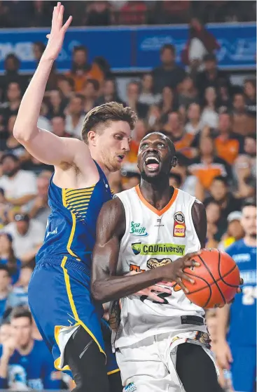  ?? Picture: AAP IMAGE ?? STANDOUT: Majok Deng, pictured being blocked by Brisbane’s Matthew Hodgson, was the Taipans’ best in a tough night out against the Bullets.